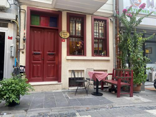 a red door and a bench in front of a building at Çırağan's Omnia Hotel in Istanbul