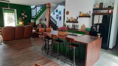 a kitchen with a wooden island in a living room at Brzozowa skarpa - dom nad jeziorem 