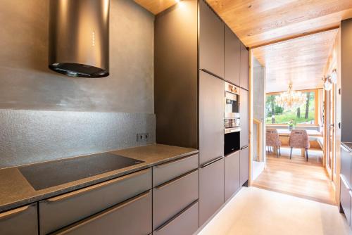 a kitchen with white cabinets and a stove at Chalet Bergfreund in Valdaora