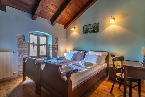 a bedroom with a bed and a table and a desk at Villa Murva in Žminj