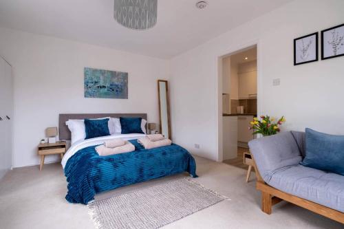 a bedroom with a large bed and a couch at Little Nye in Milford on Sea