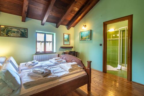 a bedroom with a bed with towels on it at Villa Murva in Žminj