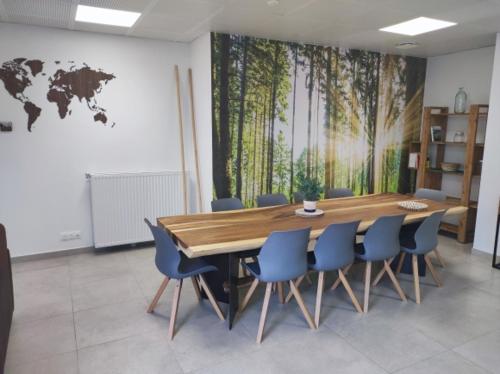 una sala conferenze con tavolo in legno e sedie blu di Neoresid Paris-Gagny a Gagny