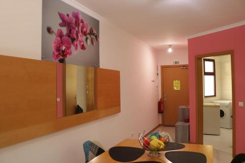 a dining room with a bowl of fruit on a table at Garajau Terrace Orchids in Caniço
