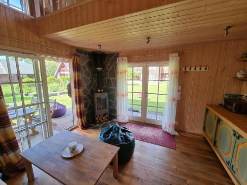a living room with a table and a door at Norwegian saunahouse in Haapse