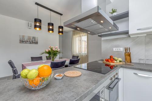 a kitchen with a counter with a bowl of fruit on it at Villa Istria Vabriga in Vabriga