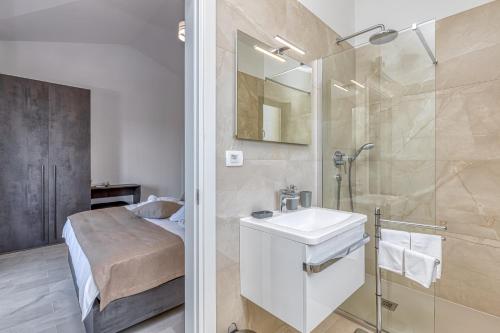 a bathroom with a sink and a shower at Villa Istria Vabriga in Vabriga