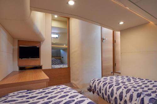 a bedroom with a bed and a tv and a mirror at Marli II in Lymington