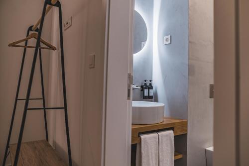 a bathroom with a sink and a mirror at Populo's Place in Ponta Delgada