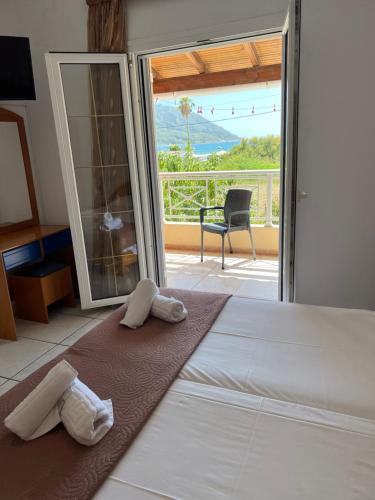 a bedroom with a bed with two towels on it at Villa Magda. in Agios Georgios Pagon