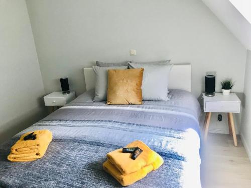 Un dormitorio con una cama con toallas amarillas. en Appartement Anne-Rose, en Beernem