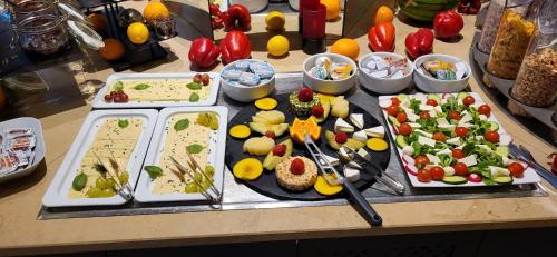 a table with plates of food on a table at DORMERO Hotel Hannover-Langenhagen Airport in Hannover