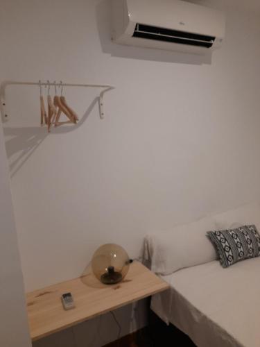a room with a bed with a table and a window at Espoz habitaciones in Madrid