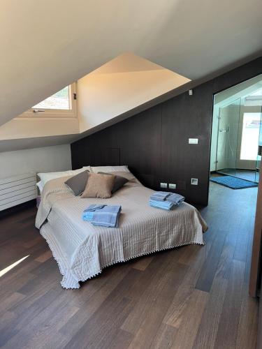 a bedroom with a bed with two towels on it at Casa Cavour Lecco - Downtown Design Penthouse in Lecco