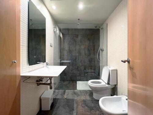 a bathroom with a sink and a toilet at Stay U-nique Apartments Venecuela in Barcelona