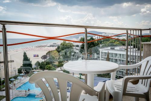 a balcony with a table and chairs and a view of the beach at Kaliakra Beach Hotel - Ultra All Inclusive in Albena
