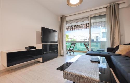 a living room with a couch and a tv at Amazing Apartment In Cannes With Wifi in Cannes
