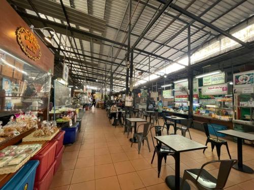 a food court with tables and chairs in a store at V20 Boutique Jacuzzi Hotel in Bangkok