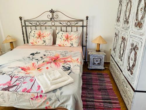 a bedroom with a large bed with flowers on it at Complex Monastery 1 -Marina Dinevi -Saint Vlas in Sveti Vlas