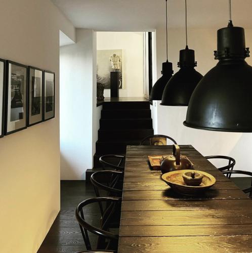 a dining room with a wooden table and chairs at Pescallo Apartments in Bellagio