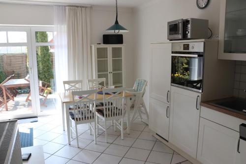 a kitchen with a table and a table and chairs at Ferienwohnung 1066 App 3 in Tossens in Tossens