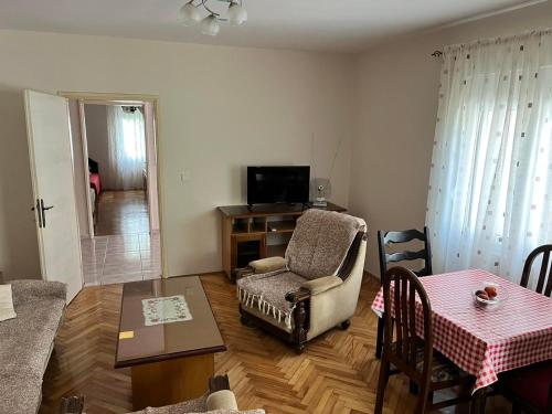 a living room with a chair and a table at Gorica hill apartment in Podgorica