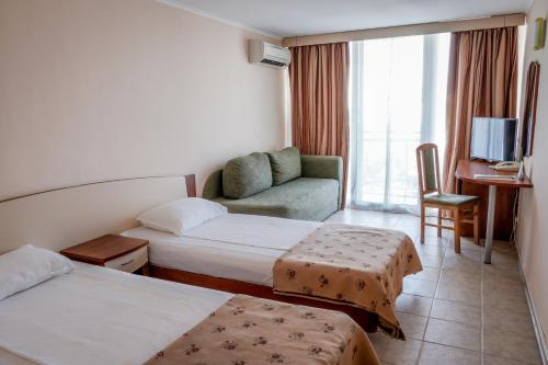 Ένα ή περισσότερα κρεβάτια σε δωμάτιο στο Hotel Malibu