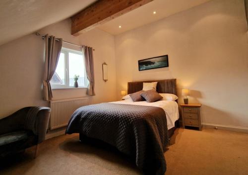 a bedroom with a bed and a window at Lake View Lodge in Saint Columb Major