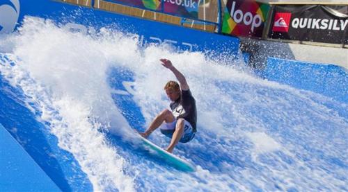 a boy riding a wave on a surfboard in a water park at Lake View Lodge in Saint Columb Major