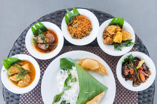 a group of plates of food on a table at Best Western Elyon Colombo in Colombo