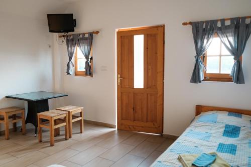 une chambre avec un lit, un bureau et une porte dans l'établissement Laguna Club Lake Resort, à Donji Žabar