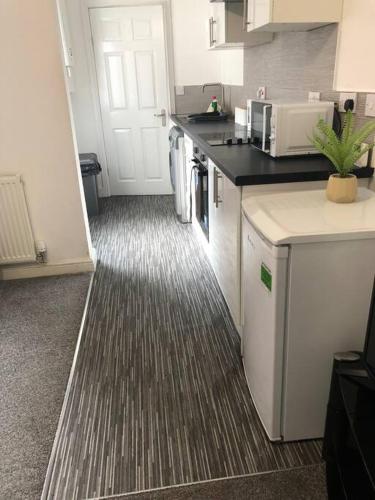 a kitchen with a sink and a counter top at Simple and sweet, Flat on Lewis Street - 1 BR in Stoke on Trent