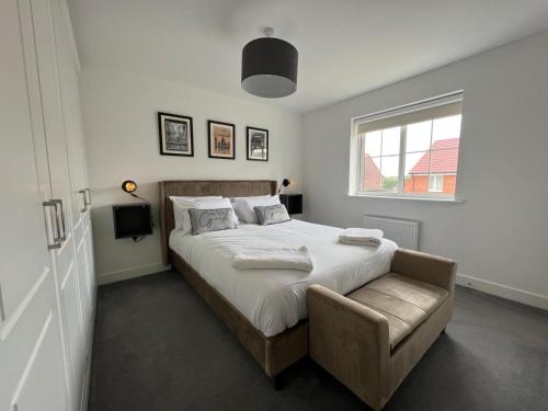 a bedroom with a bed and a chair and a window at The Cavern Fun, Stylish, Music inspired Four Bed House in Southampton