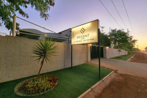 a sign for the front of a resort with a palm tree at Regent Kgale Lodge in Gaborone