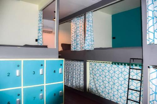a bathroom with blue cabinets and a mirror at Lost & Found Zanzibar in Zanzibar City