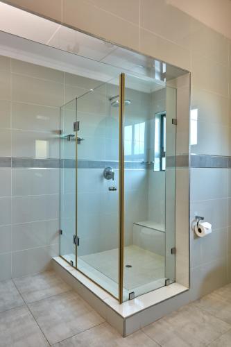a glass shower stall in a bathroom at Regent Kgale Lodge in Gaborone