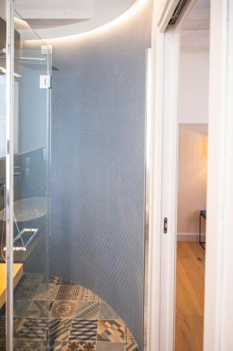 a glass shower in a bathroom with a tile floor at ViaNettuno in Civitanova Marche