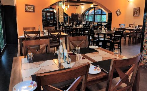 a restaurant with tables and chairs in a room at Chira Meadows Ecoresort, Dapoli in Dapoli
