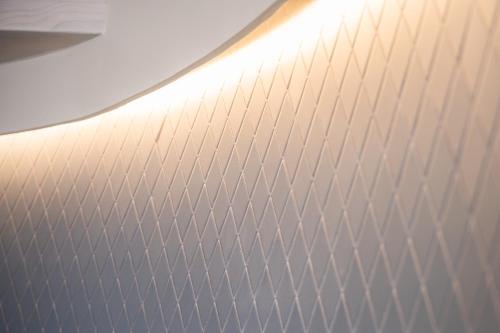 a white wall with a metal pattern on it at ViaNettuno in Civitanova Marche