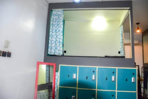 a mirror and some blue cabinets in a room at Lost & Found Zanzibar in Zanzibar City