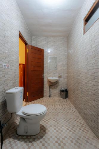 a bathroom with a toilet and a sink at BUBU CANGGU Guesthouse in Canggu