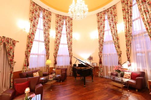 a living room filled with furniture and a grand piano at Memory Garden in Luodong