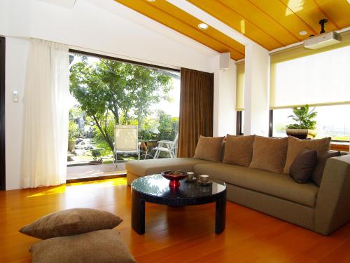 a living room with a couch and a table at Memory Garden in Luodong