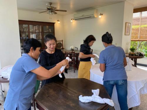 a group of women standing around a table with towels at SSIP Boutique Dhevej Bangkok in Bangkok