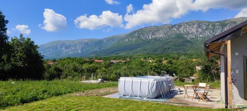 a white refrigerator sitting on a patio with mountains in the background at Apartmani Petrović SEMČE Suva Planina in Gadžin Han