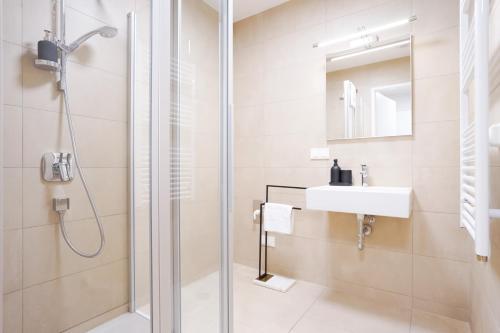 een badkamer met een douche en een wastafel bij Exclusive 2-Bedroom condo with Pool & Balcony in Wenen