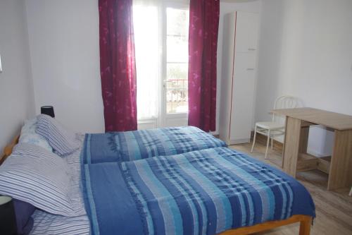 une chambre avec un lit, une table et une fenêtre dans l'établissement Villa Nausicaa, à Hyères