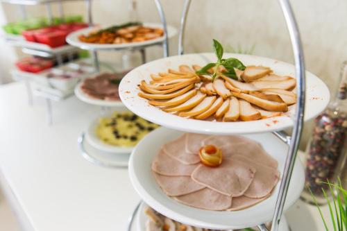 a bunch of plates of food on a shelf at Best Western Elyon Colombo in Colombo