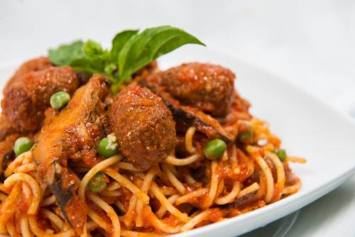 a plate of food with spaghetti and meatballs at Best Western Elyon Colombo in Colombo