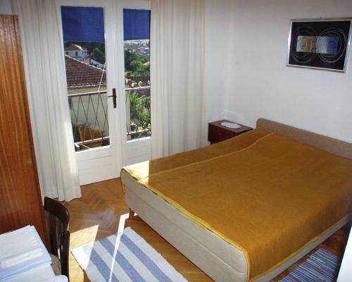 a bedroom with a bed and a large window at Rooms by the sea Jelsa, Hvar - 127 in Jelsa